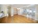 Open-concept living and dining area featuring hardwood floors, fireplace and abundant natural light at 7037 Ladys Secret Dr, Indian Trail, NC 28079