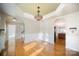 Elegant dining room with hardwood floors, wainscoting, a decorative chandelier, and arched doorways at 7037 Ladys Secret Dr, Indian Trail, NC 28079