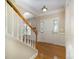 Welcoming foyer showcasing hardwood floors, elegant wainscoting, and a staircase with wooden banister at 7037 Ladys Secret Dr, Indian Trail, NC 28079