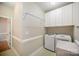 This laundry room includes modern washer and dryer with plenty of cabinet storage at 7037 Ladys Secret Dr, Indian Trail, NC 28079