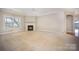A spacious carpeted living room includes a fireplace and bright natural light at 7037 Ladys Secret Dr, Indian Trail, NC 28079