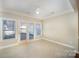 This living room boasts tile floors, large windows, and access to an outdoor space at 7037 Ladys Secret Dr, Indian Trail, NC 28079
