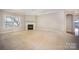 A spacious carpeted living room includes a fireplace and plenty of natural light at 7037 Ladys Secret Dr, Indian Trail, NC 28079