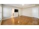 This large main bedroom includes a ceiling fan, hardwood floors, and ensuite bathroom access at 7037 Ladys Secret Dr, Indian Trail, NC 28079