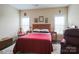 Cozy bedroom with natural light, complemented by a plush bed and soft rug at 822 Wisteria Way, Salisbury, NC 28146