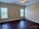 This bedroom has dark floors and natural light from the two windows at 822 Wisteria Way, Salisbury, NC 28146