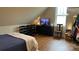 Well-organized bedroom featuring wood floors, a TV, storage, and a cozy bed with natural light at 822 Wisteria Way, Salisbury, NC 28146