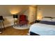 Comfortable bedroom featuring warm lighting, wood floors, and a cozy reading nook with an armchair at 822 Wisteria Way, Salisbury, NC 28146