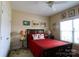 Bedroom featuring a queen bed, complimented by a lamp and decor at 822 Wisteria Way, Salisbury, NC 28146