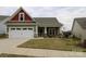 Charming exterior showcasing a well-manicured lawn, colorful accents, and an inviting front entrance at 822 Wisteria Way, Salisbury, NC 28146