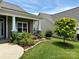 Exterior home view showcasing a well-manicured lawn and colorful flower beds enhancing the property's curb appeal at 822 Wisteria Way, Salisbury, NC 28146