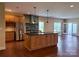 Spacious kitchen and living room with modern stainless steel appliances, a central island, and hardwood floors at 822 Wisteria Way, Salisbury, NC 28146