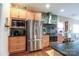 Well-lit kitchen featuring stainless steel appliances and ample cabinet space at 822 Wisteria Way, Salisbury, NC 28146