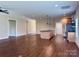 Expansive living room with hardwood floors, a central island, and modern kitchen appliances at 822 Wisteria Way, Salisbury, NC 28146
