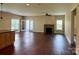 Bright, open-concept living room featuring a cozy fireplace, hardwood floors, and access to outdoor space at 822 Wisteria Way, Salisbury, NC 28146