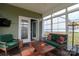 Inviting sunroom featuring a green couch, wood coffee table, and ample natural light at 822 Wisteria Way, Salisbury, NC 28146
