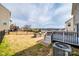 Spacious backyard with a deck, stone grill, and black metal fence, perfect for outdoor entertaining at 844 Braddock Way, Fort Mill, SC 29715