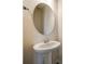 Elegant powder room features a pedestal sink and oval mirror at 844 Braddock Way, Fort Mill, SC 29715