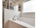 Modern soaking tub with sleek fixtures and a tiled shower at 844 Braddock Way, Fort Mill, SC 29715
