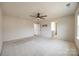 Large bedroom with neutral carpet, ceiling fan, and entry to the bathroom at 844 Braddock Way, Fort Mill, SC 29715