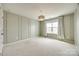 A bedroom with light green walls and a woven-shade pendant lamp at 844 Braddock Way, Fort Mill, SC 29715