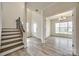 Welcoming foyer with wood-look flooring, stairs and view to the dining room at 844 Braddock Way, Fort Mill, SC 29715