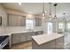 Well-lit kitchen boasts quartz countertops, stainless steel appliances, and wood grain flooring at 844 Braddock Way, Fort Mill, SC 29715