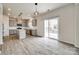 Modern kitchen with stainless steel appliances, island, and sliding glass door to patio at 844 Braddock Way, Fort Mill, SC 29715