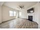 Spacious living room with a cozy fireplace and wood-look floors at 844 Braddock Way, Fort Mill, SC 29715