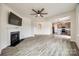 Open-concept living room with a fireplace and seamless flow to the kitchen at 844 Braddock Way, Fort Mill, SC 29715