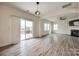 Open layout combining a sliding glass door to patio and living room with fireplace at 844 Braddock Way, Fort Mill, SC 29715