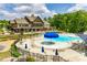 Community pool and clubhouse area with ample seating, umbrellas, and a spacious deck at 844 Braddock Way, Fort Mill, SC 29715