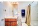 Well-lit bathroom featuring a wood vanity, framed mirror, tiled flooring, and shower-tub combo at 9741 Turning Wheel Dr, Charlotte, NC 28214