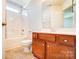 Clean bathroom featuring a vanity, toilet, bathtub with shower, and tile floors at 9741 Turning Wheel Dr, Charlotte, NC 28214