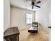 Bright bedroom with a modern chaise lounge, window, and ceiling fan at 9741 Turning Wheel Dr, Charlotte, NC 28214
