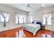 Bright bedroom with hardwood floors, a ceiling fan, and natural light from the windows at 9741 Turning Wheel Dr, Charlotte, NC 28214