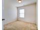 Bedroom features a bright window, neutral walls, and carpeted floors for a cozy feel at 9741 Turning Wheel Dr, Charlotte, NC 28214