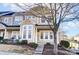 Charming townhome featuring neutral siding, multi-pane windows, and a welcoming front entrance at 9741 Turning Wheel Dr, Charlotte, NC 28214