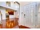 Welcoming foyer with hardwood floors and view into the open kitchen and living area at 9741 Turning Wheel Dr, Charlotte, NC 28214