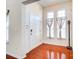 Bright foyer with hardwood floors, two windows, and neutral tones at 9741 Turning Wheel Dr, Charlotte, NC 28214
