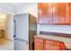 Kitchen with stainless steel refrigerator and brown cabinets at 9741 Turning Wheel Dr, Charlotte, NC 28214