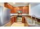 Kitchen with stainless steel appliances and brown cabinets at 9741 Turning Wheel Dr, Charlotte, NC 28214