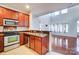 The kitchen features stainless steel appliances, brown cabinets, and a double sink at 9741 Turning Wheel Dr, Charlotte, NC 28214