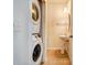 The stackable washer and dryer are located in a hallway next to a half bathroom at 9741 Turning Wheel Dr, Charlotte, NC 28214