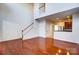 Open-concept living room with hardwood floors and a staircase at 9741 Turning Wheel Dr, Charlotte, NC 28214