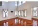 Open living room with hardwood floors and multiple windows at 9741 Turning Wheel Dr, Charlotte, NC 28214