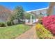 Beautifully landscaped backyard with a brick pathway and a covered patio at 1012 Equipoise Dr, Indian Trail, NC 28079