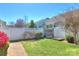 Serene backyard featuring a charming wooden gate and lush landscaping at 1012 Equipoise Dr, Indian Trail, NC 28079