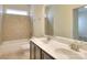 Bathroom featuring double sink vanity, shower-tub combo, tiled walls, and tile flooring at 1012 Equipoise Dr, Indian Trail, NC 28079