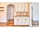Charming butler's pantry featuring custom cabinets, granite countertops, and decorative tiled backsplash at 1012 Equipoise Dr, Indian Trail, NC 28079